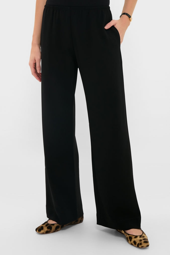 Model wearing Black Arielle Pocket Pants with a relaxed, wide-leg fit and side pockets, paired with leopard-print flat shoes for an effortless, classic look.