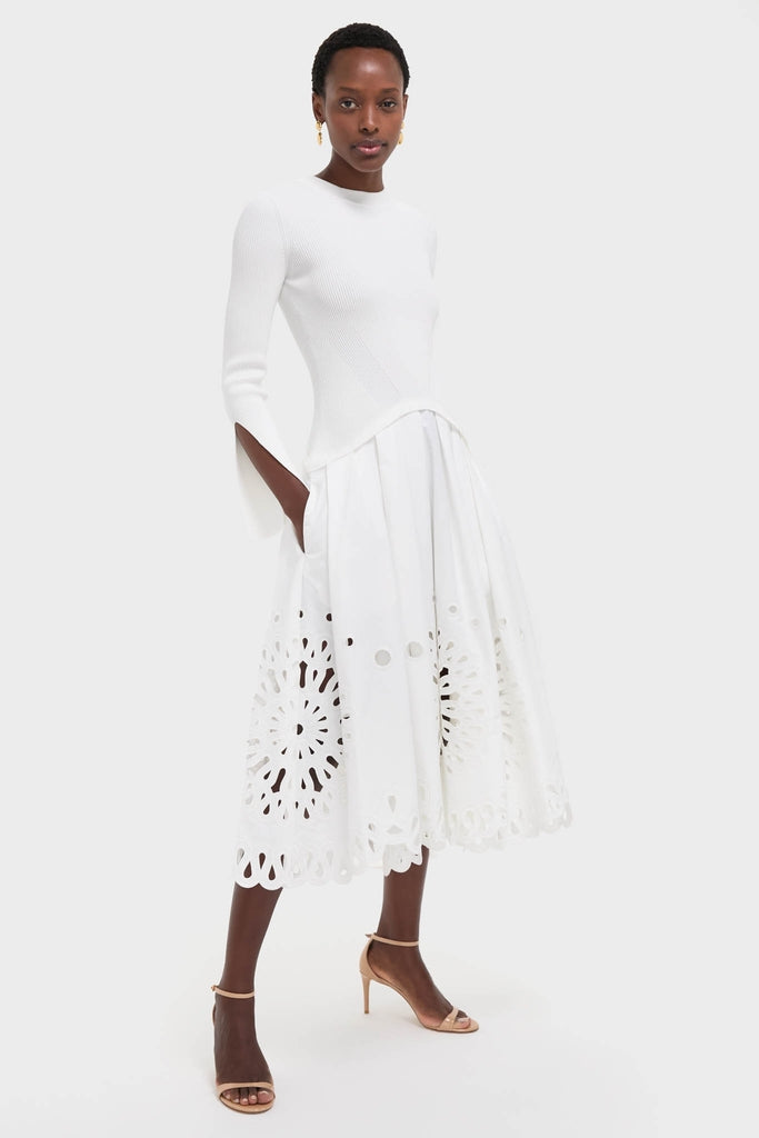 White Daila Midi Dress: Classic, effortless elegance with a ribbed knit bodice, slit sleeves, and eyelet cotton skirt. Perfect for fun, high-end occasions.