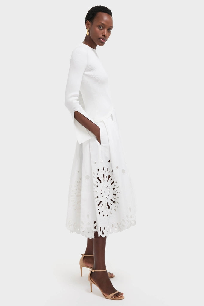 White Daila Midi Dress with ribbed knit bodice, slit sleeves, and eyelet-embroidered skirt. A classic, effortless, high-end look perfect for fun, stylish occasions.