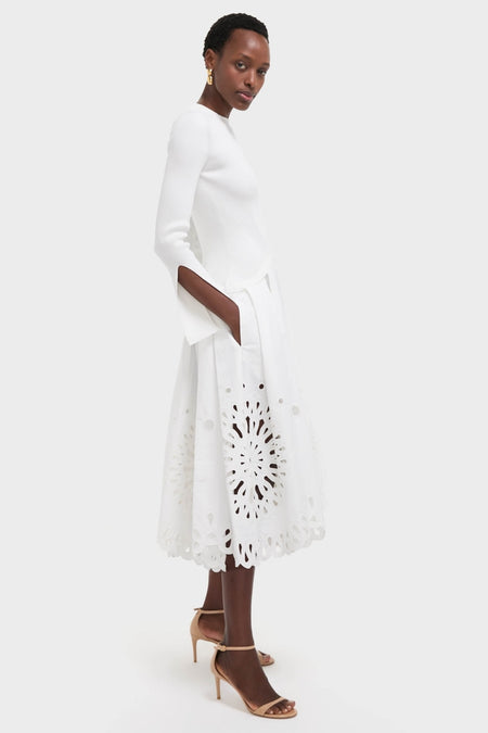 White Daila Midi Dress with ribbed knit bodice, slit sleeves, and eyelet-embroidered skirt. A classic, effortless, high-end look perfect for fun, stylish occasions.