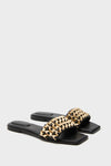 Black Faye Beaded Leather Flat Slides feature a classic square-toed design with an effortless lattice-style gold metal strap, offering a fun yet high-end look for any occasion.