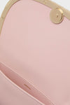 Close-up of the Pale Pink Logan Leather Crossbody's interior, showcasing smooth lining, a classic gold-tone frame, and SIMKHAI gold stamp, reflecting effortless, high-end style.