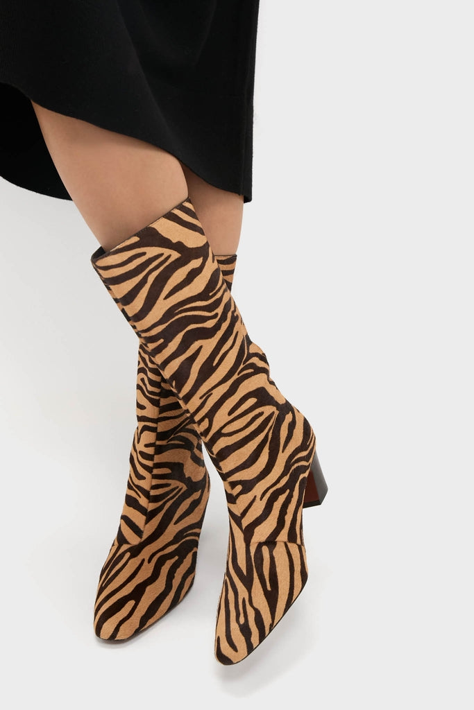 Zebra Cleo Boots showcase a classic zebra-style print, featuring a pointed toe and block heel for an effortless, high-end look. Perfect for fun, confident style.