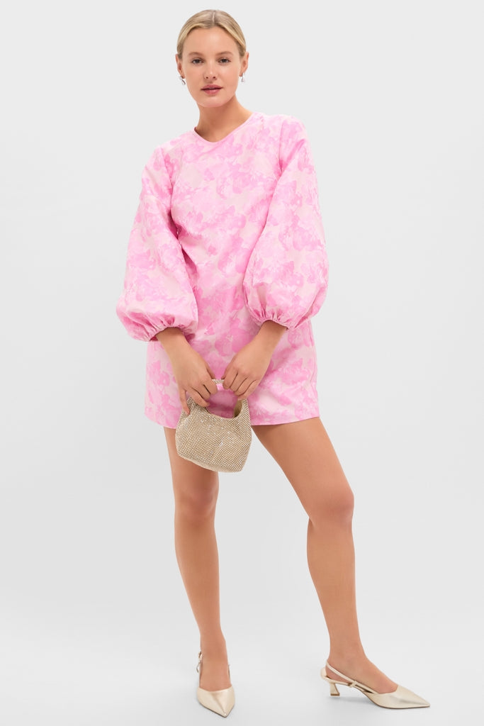 Young woman in a pastel-pink dress holds the classic Gold Diamante Kenzie Bag, showcasing its sparkling, high-end design. Perfect for effortless, fun occasions.