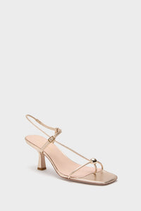 Champagne Metallic Triana Heels: Classic and effortless strappy sandal with a low kitten heel, fun T-strap, and gold ball detail, perfect for high-end occasions.