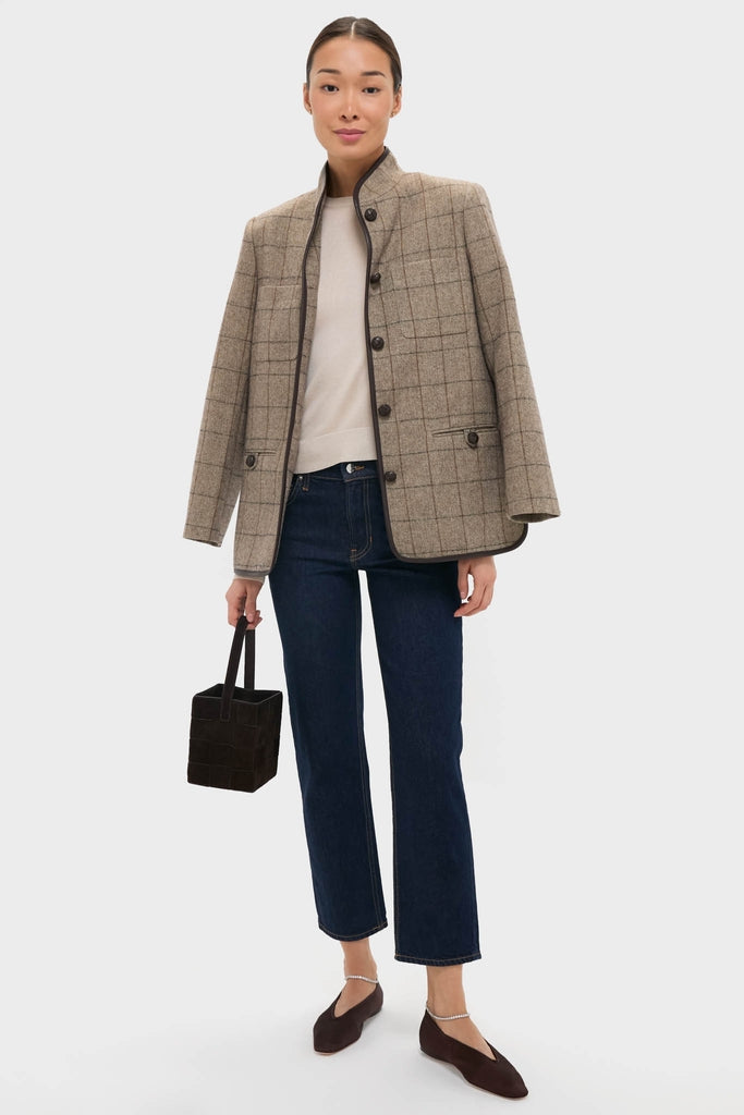 Model wearing classic dark brown satin Emery Flats with crystals, styled effortlessly with indigo jeans and a wool jacket, exuding a high-end, fun autumnal look.