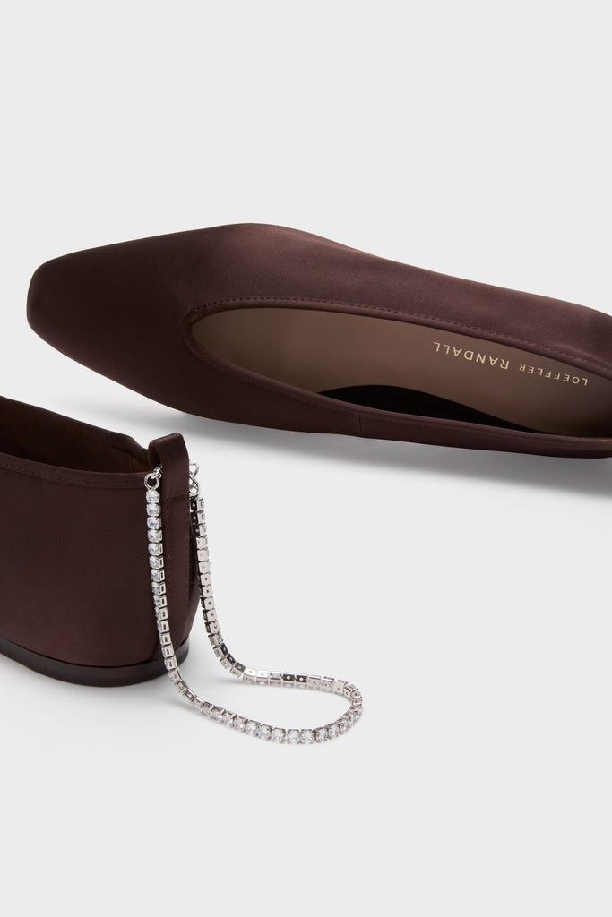 Dark Brown Satin with Crystals Emery Flats showcase classic elegance with an effortless, high-end style, featuring a crystal-stone chain and Loeffler Randall branding.