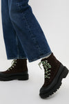 The Tmoro Remy Boots showcase a classic, effortless style with their chunky lug soles and green-patterned laces, ideal for high-end, fun, and casual looks.