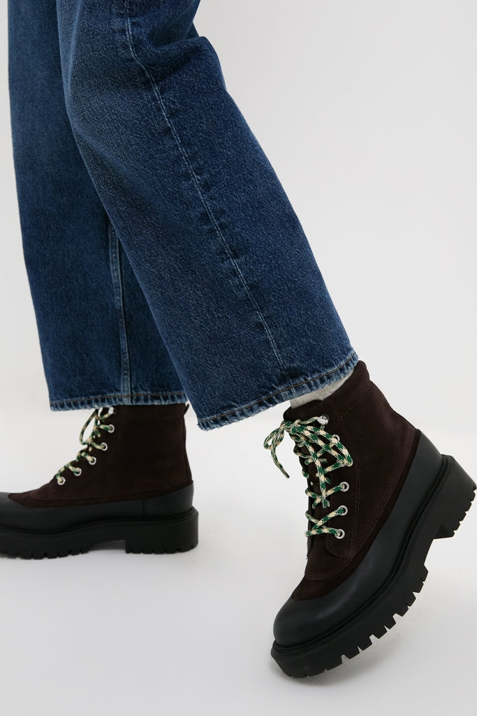 The Tmoro Remy Boots showcase a classic, effortless style with their chunky lug soles and green-patterned laces, ideal for high-end, fun, and casual looks.