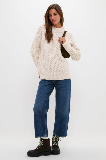 Woman wearing Tmoro Remy Boots: classic lug-sole, lace-up design. Effortlessly styled with jeans and a sweater, capturing a high-end, fun, and confident look.