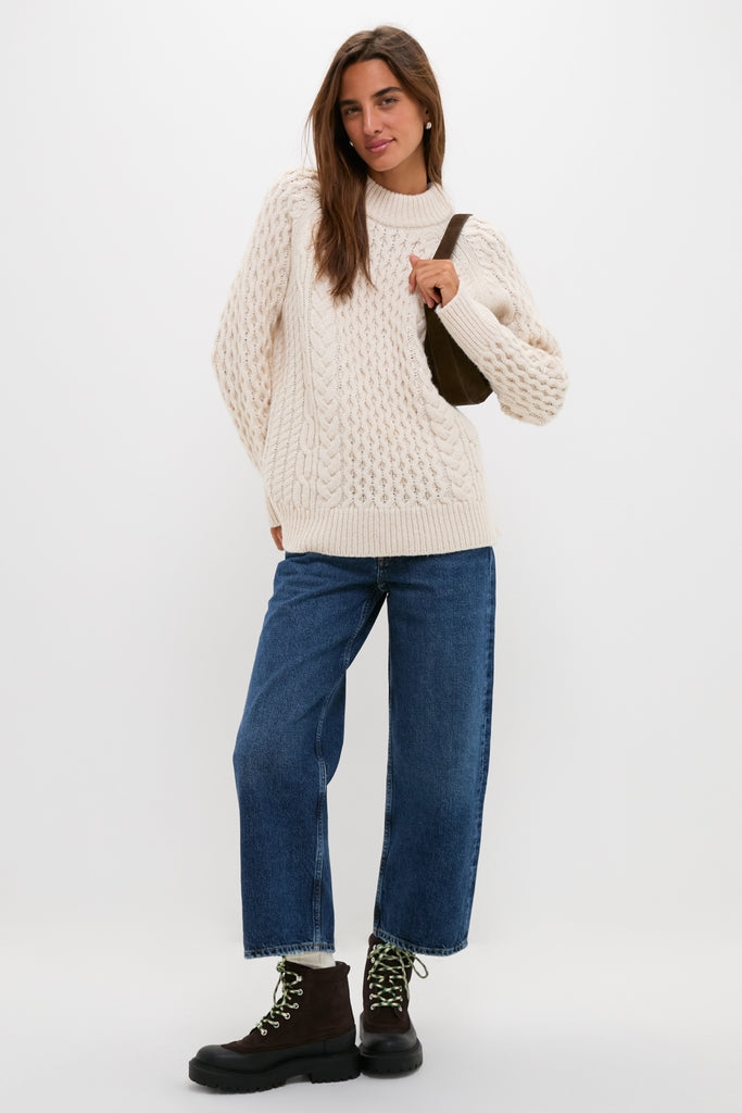 Woman wearing Tmoro Remy Boots: classic lug-sole, lace-up design. Effortlessly styled with jeans and a sweater, capturing a high-end, fun, and confident look.