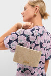 Woman in profile wearing a floral top and gold drop earrings, showcasing the Gold Rhinestone Diamante Clutch—a classic, high-end bag with sparkling crystals and metallic strap. Effortless elegance.