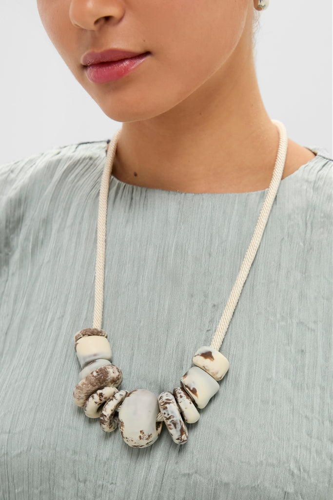 Cappuccino Drift Choker: A classic, high-end necklace featuring unique, cream-colored resin beads on an adjustable cord, offering an effortless and fun way to elevate your style.