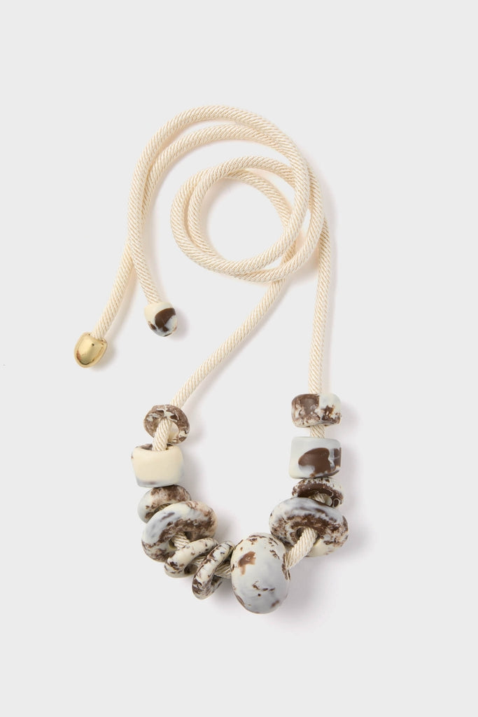 Cappuccino Drift Choker featuring classic, irregular cream and chocolate resin beads on an adjustable, high-end wood-silk cord. Effortlessly elevates any look with fun texture.