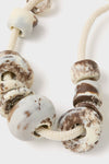 Cappuccino Drift Choker: A classic, effortless accessory with chunky, marbled beads on an adjustable rope cord, offering a fun and high-end touch to any outfit.