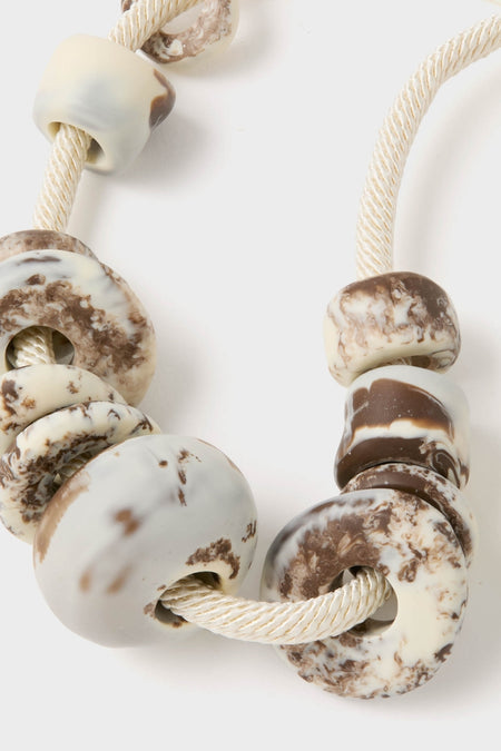 Cappuccino Drift Choker: A classic, effortless accessory with chunky, marbled beads on an adjustable rope cord, offering a fun and high-end touch to any outfit.