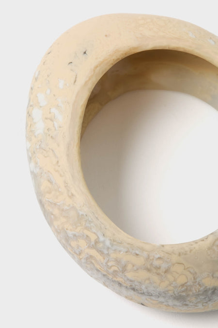 Sandy Pearl Rock Medium Bangle: A classic, torus-shaped ceramic vessel with a smooth interior, exuding effortless elegance and fun, high-end style. Perfect for elevating any collection.