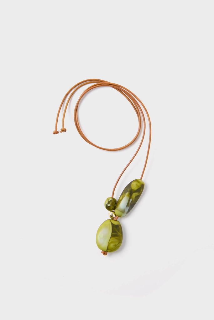 Malachite Brass Rock Cluster Pendant: A classic, high-end necklace featuring three green marbled resin beads on an effortless, adjustable tan leather cord for a fun, modern look.