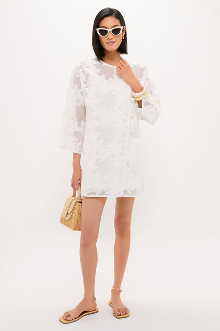 Woman in a classic, semi-sheer lace dress, accessorized with a Lemon Rock Small Bangle in butter yellow, exuding effortless, high-end style.