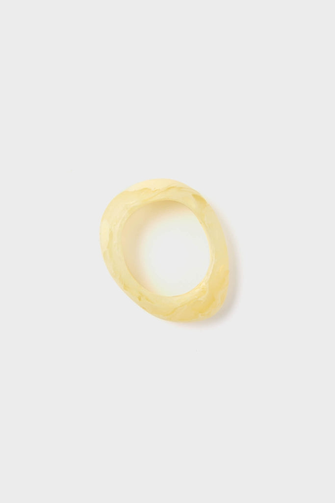 Lemon Rock Small Bangle in marbled yellow resin, featuring an organic silhouette. A classic, effortless accessory that embodies fun and high-end style, perfect for versatile wear.