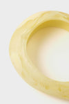 Lemon Rock Small Bangle: A classic, marbled yellow resin bracelet with an effortless, organic silhouette. Perfect for fun, high-end styling, whether worn alone or layered.