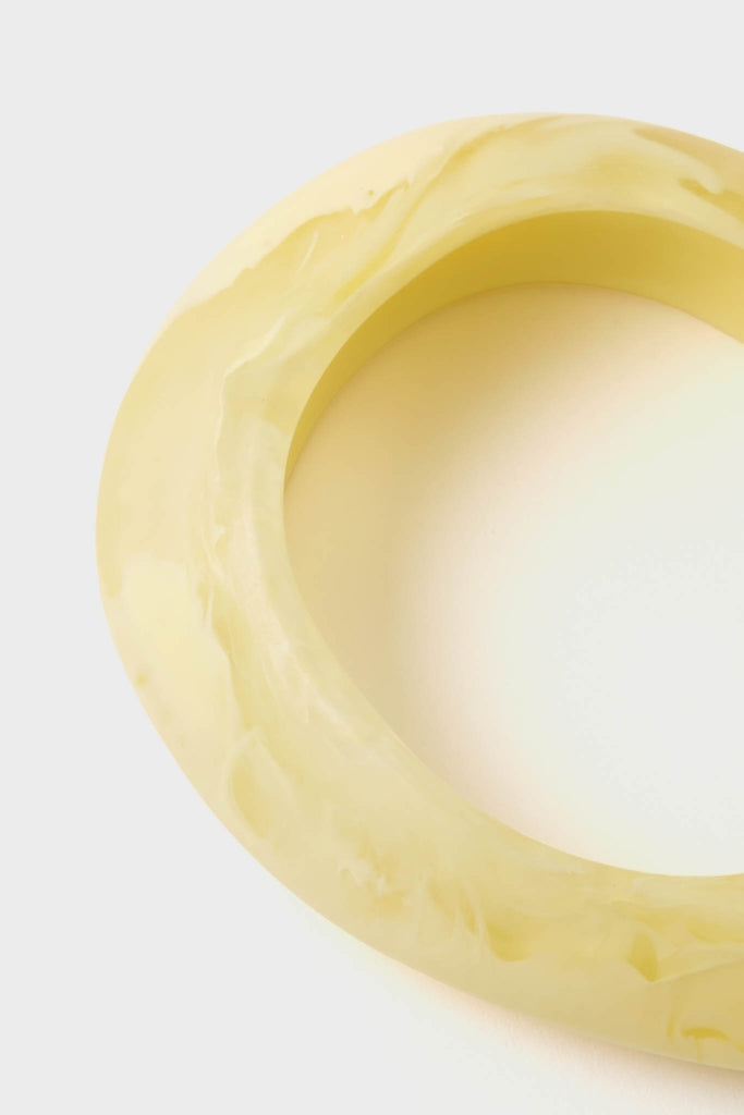 Lemon Rock Small Bangle: A classic, marbled yellow resin bracelet with an effortless, organic silhouette. Perfect for fun, high-end styling, whether worn alone or layered.