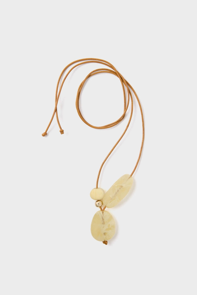 Lemon Brass Rock Cluster Pendant: A classic, fun necklace featuring translucent yellow resin beads on a light tan leather cord, exuding an effortless, high-end bohemian charm.