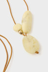 Lemon Brass Rock Cluster Pendant: A classic, high-end necklace featuring three resin beads on an adjustable leather cord, offering an effortless and fun accessory for any outfit.