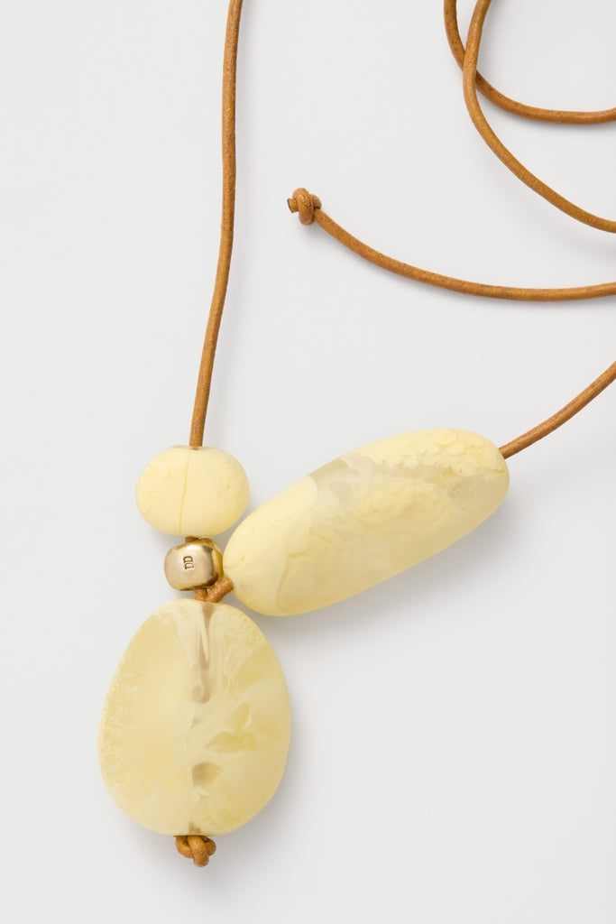 Lemon Brass Rock Cluster Pendant on leather cord, featuring three classic resin beads and gold spacer, offering an effortless, high-end touch to any outfit.