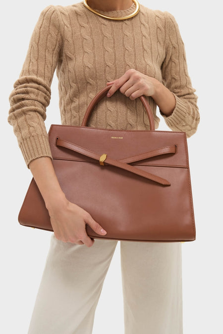Hazelwood Large Veronica Beard Dash Bag, a classic, high-end leather tote with top handle and removable strap, held by a woman in an effortless, chic style.