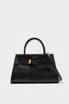 Black Veronica Beard Dash Bag in smooth leather; a classic, effortless trapezoidal tote with a top handle, detachable strap, and gold clasp detail for high-end versatility.