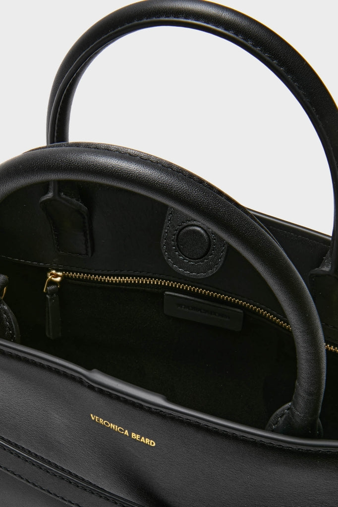 Black Veronica Beard Dash Bag, a classic, high-end leather tote with effortless style features rounded top handles, gold-stamped branding, and versatile straps for fun, everyday use.