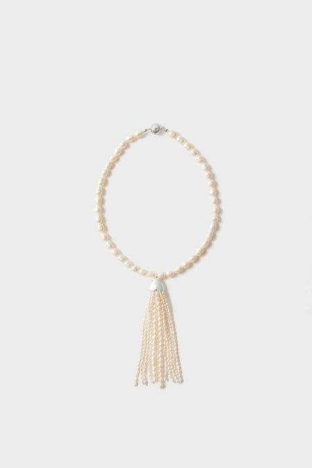 Pearl Delfina Necklace: A classic, high-end single-strand ivory pearl necklace with an effortless multi-strand tassel pendant, offering a fun touch of elegance.
