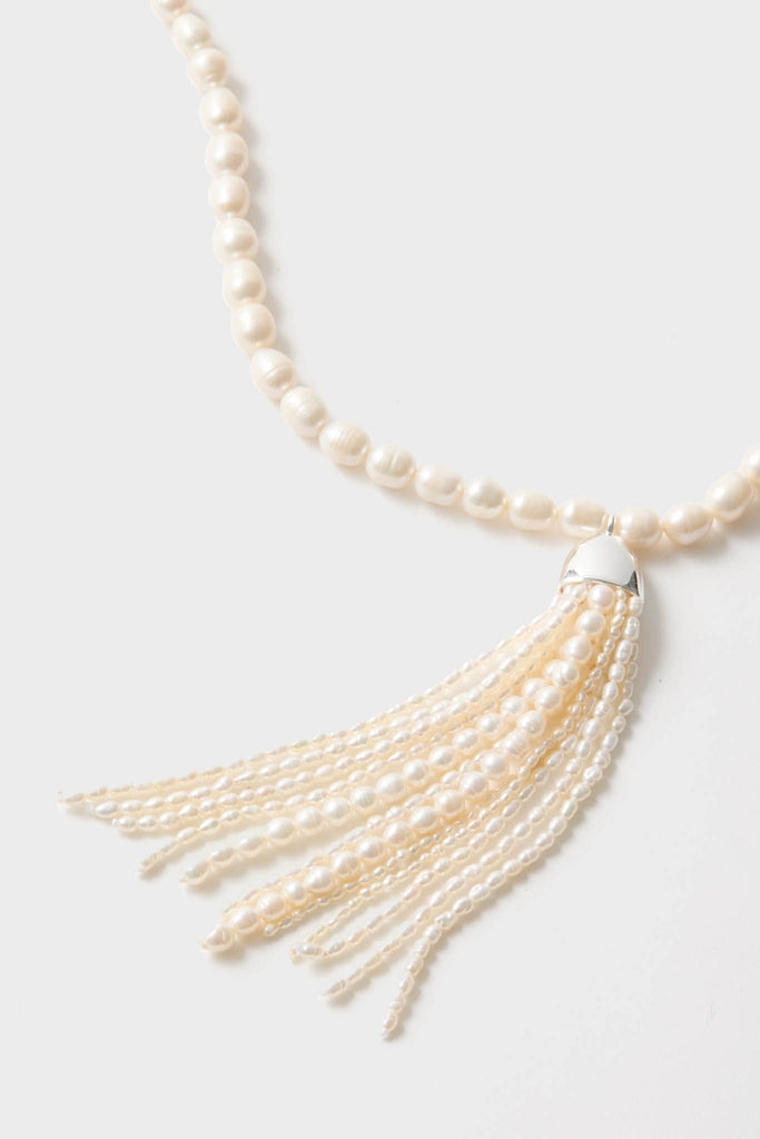 Pearl Delfina Necklace features classic, irregularly shaped freshwater pearls with an effortless tassel pendant, embodying a fun and high-end style.