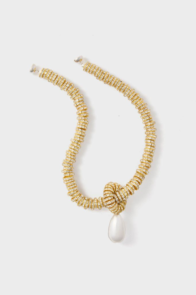 Gold Pearl Drop Necklace features a classic, effortless design with a gold-tone crystal-encrusted chain, decorative knot, and teardrop pearl-like pendant for a fun, high-end look.