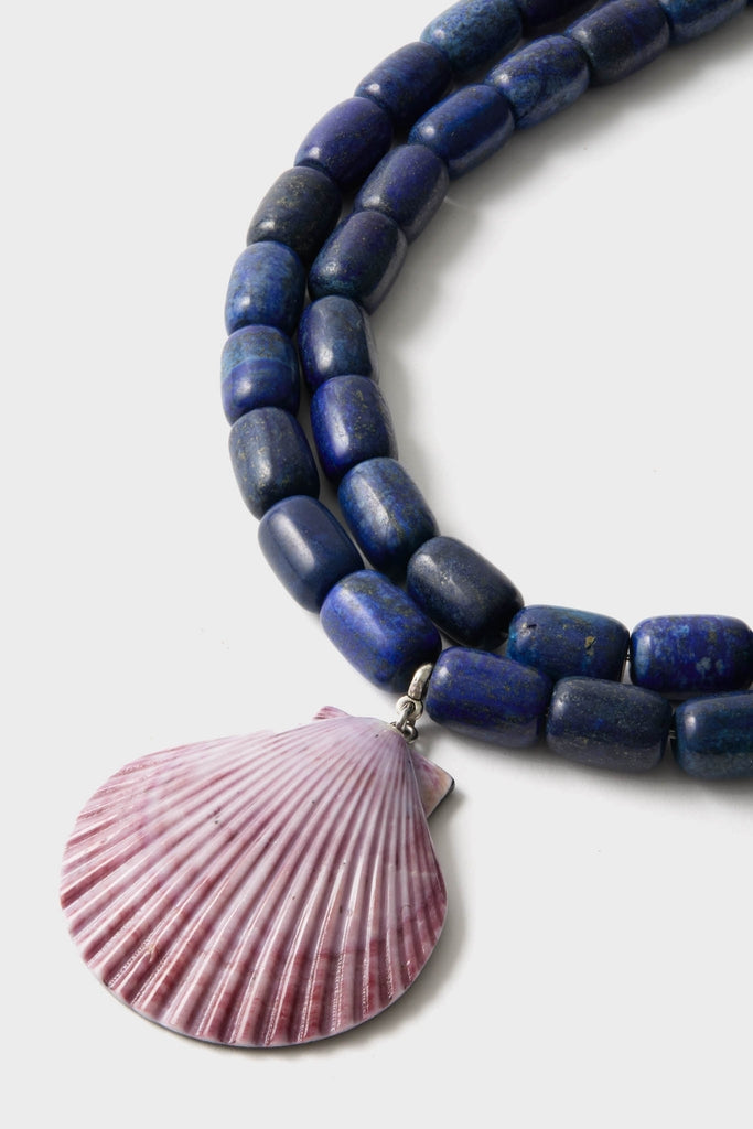 Navy and Lilac Luma Necklace featuring chunky blue beads and a scallop shell pendant, exuding a classic and effortlessly cool high-end style.