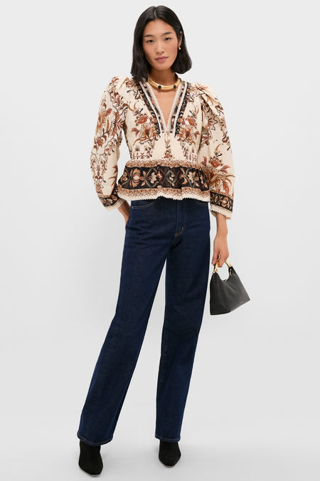 Person wearing a classic, effortless ensemble with a Gold Celeste Necklace, showcasing fun elegance. Styled with high-end dark jeans, boots, and a chic handbag.