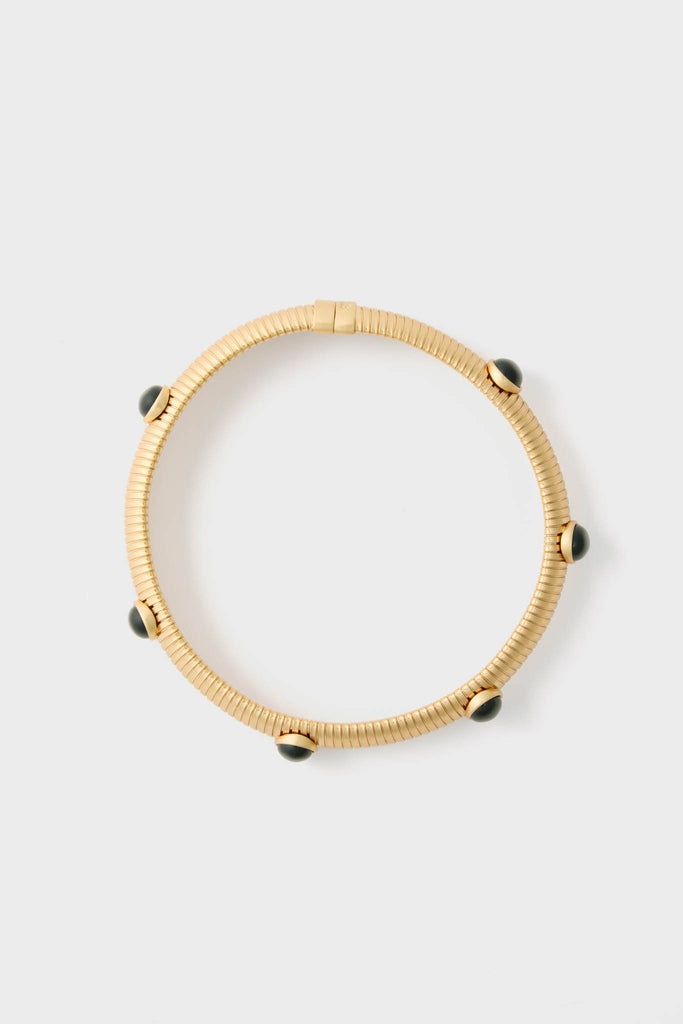 Gold Celeste Necklace: A classic, high-end, coiled gold-tone bangle with five black cabochon accents. Effortless elegance for a fun, stylish look.