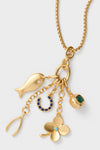 Gold Buona Fortuna Necklace: Classic gold-tone chain with playful, lucky-charm motifs—fish, wishbone, horseshoe, clover, emerald bead—offering an effortless, high-end accessory for everyday fun.