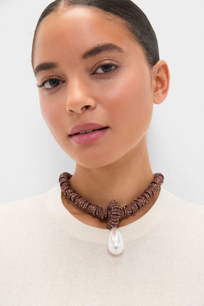 Young woman wearing the Brown Pearl Drop Necklace, a classic, high-end choker with dark bronze beads and an effortless, fun teardrop-shaped pearl centerpiece.