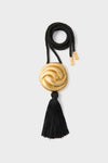 Gold and Black Hebe Necklace featuring a classic twisted black cord with gold-tone accents and a black tassel, offering an effortless, high-end aesthetic.