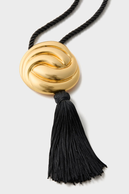 Gold and Black Hebe Necklace: A classic, high-end statement piece featuring an effortless black braided cord with a fun, stylish tassel and sculpted gold-tone bead.