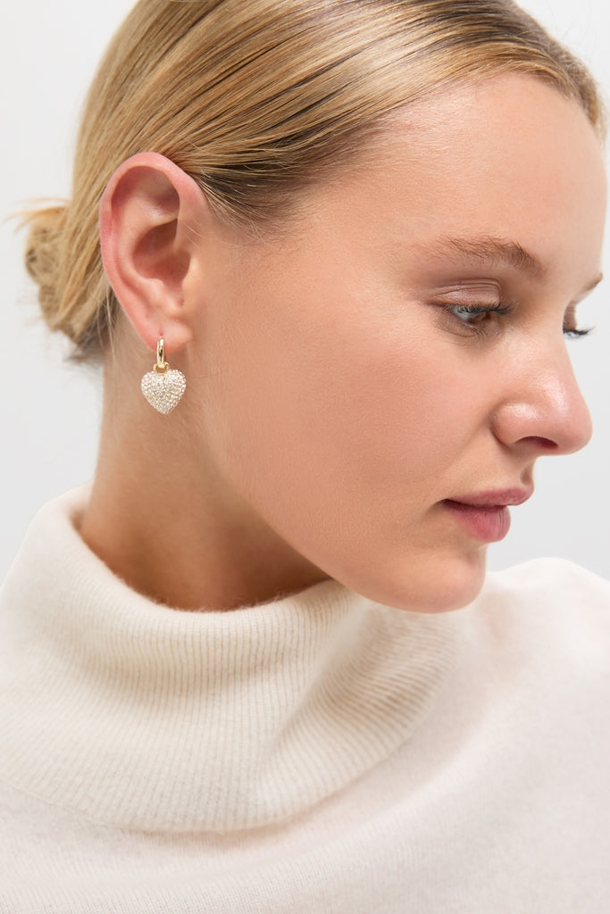 Gold The Mini Pave Puffy Heart Earrings, featuring crystal-encrusted heart charms on gold hoops, offer an effortless, high-end sparkle for a classic, fun style.