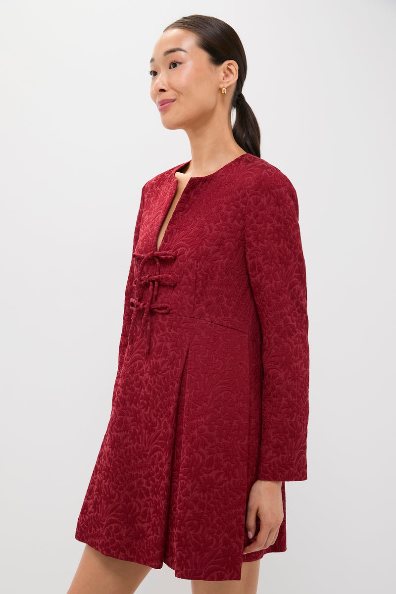 Model in the Cranberry Jacquard Blair Bow Dress, showcasing classic elegance with frog-style closures, pleated skirt, and jacquard texture for an effortless, high-end look.