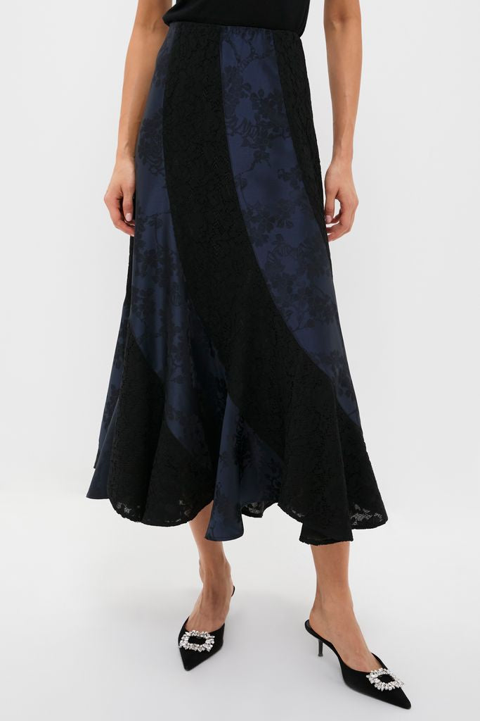 Navy Jacquard and Black Lace Mallory Skirt features an effortless, high-end A-line silhouette with an asymmetrical hem, paired with classic pointed-toe mule heels for a fun look.