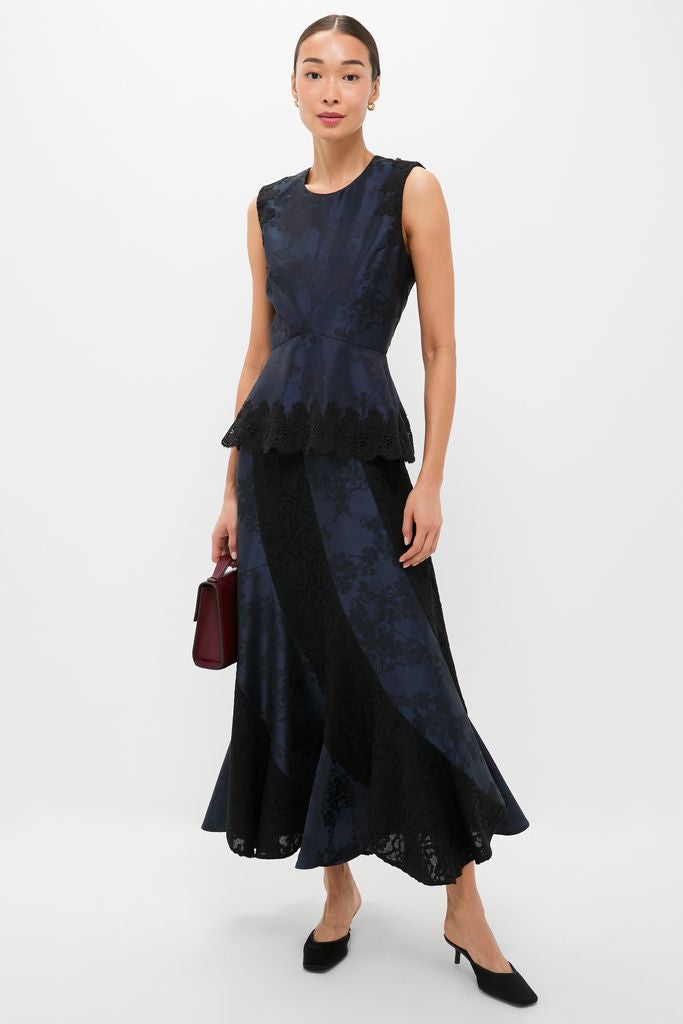 Model wearing a classic Navy Jacquard and Black Lace Mallory Skirt with a fun, high-end mermaid silhouette, paired effortlessly with a sleeveless fitted top.