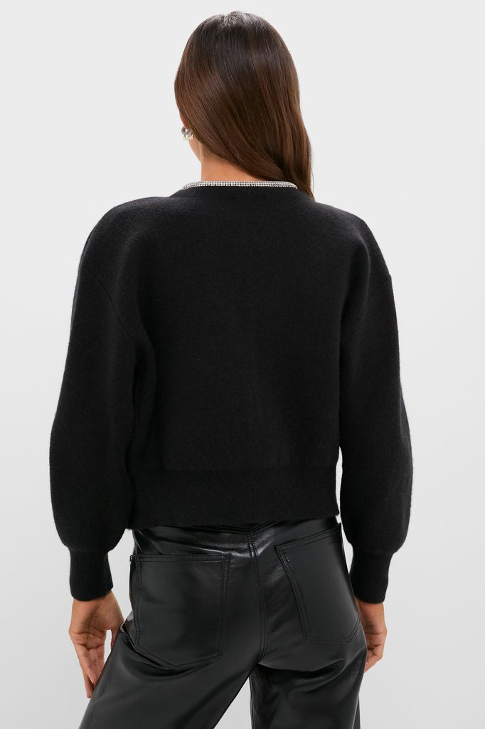 Black Sequin Trim Naomi Cardigan, a classic and effortless sweater with sparkly neckline trim, paired with high-waisted leather pants for a fun, high-end look.