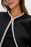 Black Sequin Trim Naomi Cardigan with sparkling trim detail against dark knit fabric, exuding a classic, effortless, and high-end style. Perfect for adding a touch of fun.