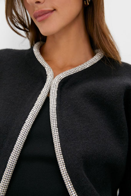 Black Sequin Trim Naomi Cardigan with sparkling trim detail against dark knit fabric, exuding a classic, effortless, and high-end style. Perfect for adding a touch of fun.