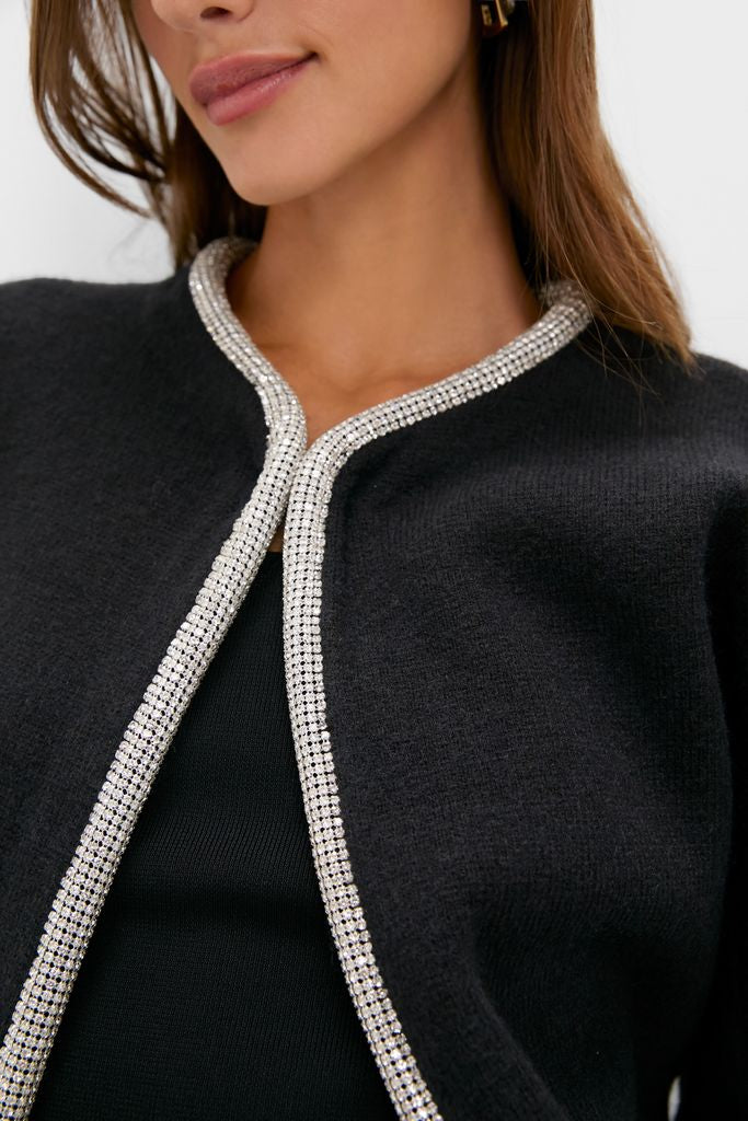Black Sequin Trim Naomi Cardigan with sparkling trim detail against dark knit fabric, exuding a classic, effortless, and high-end style. Perfect for adding a touch of fun.